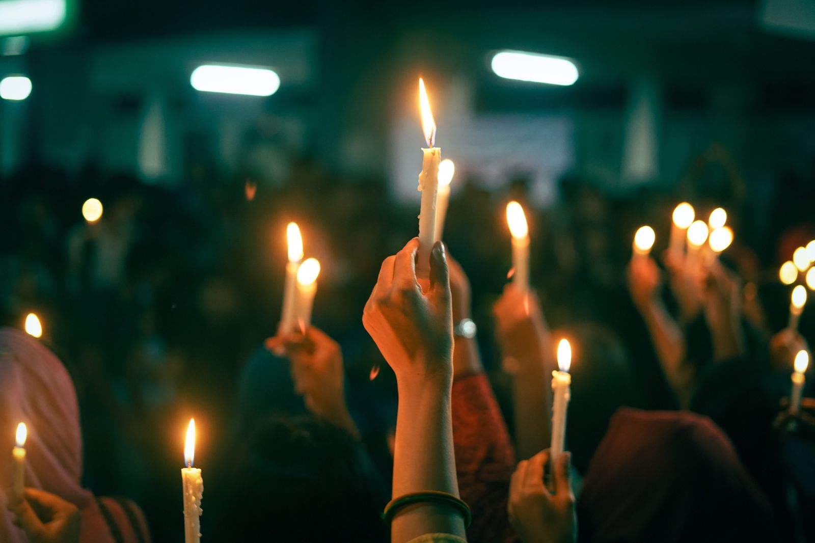 People holding candles together in solidarity