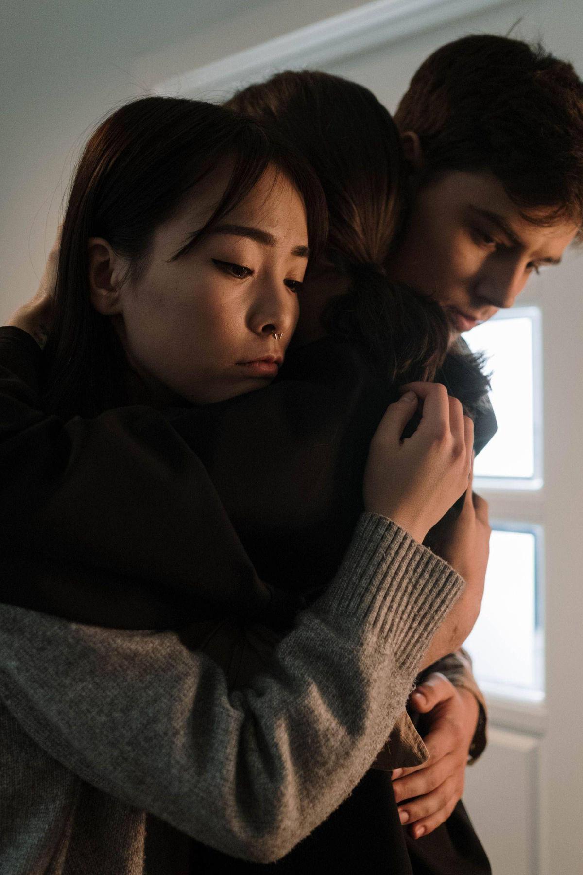 People supporting each other with a hug